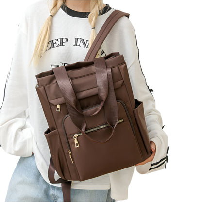 A woman carrying a brown one-shoulder dual-use fashion bag with a zipper.