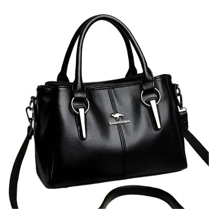 A black leather handbag with a shoulder strap, front metal hardware, and a horizontal square shape.